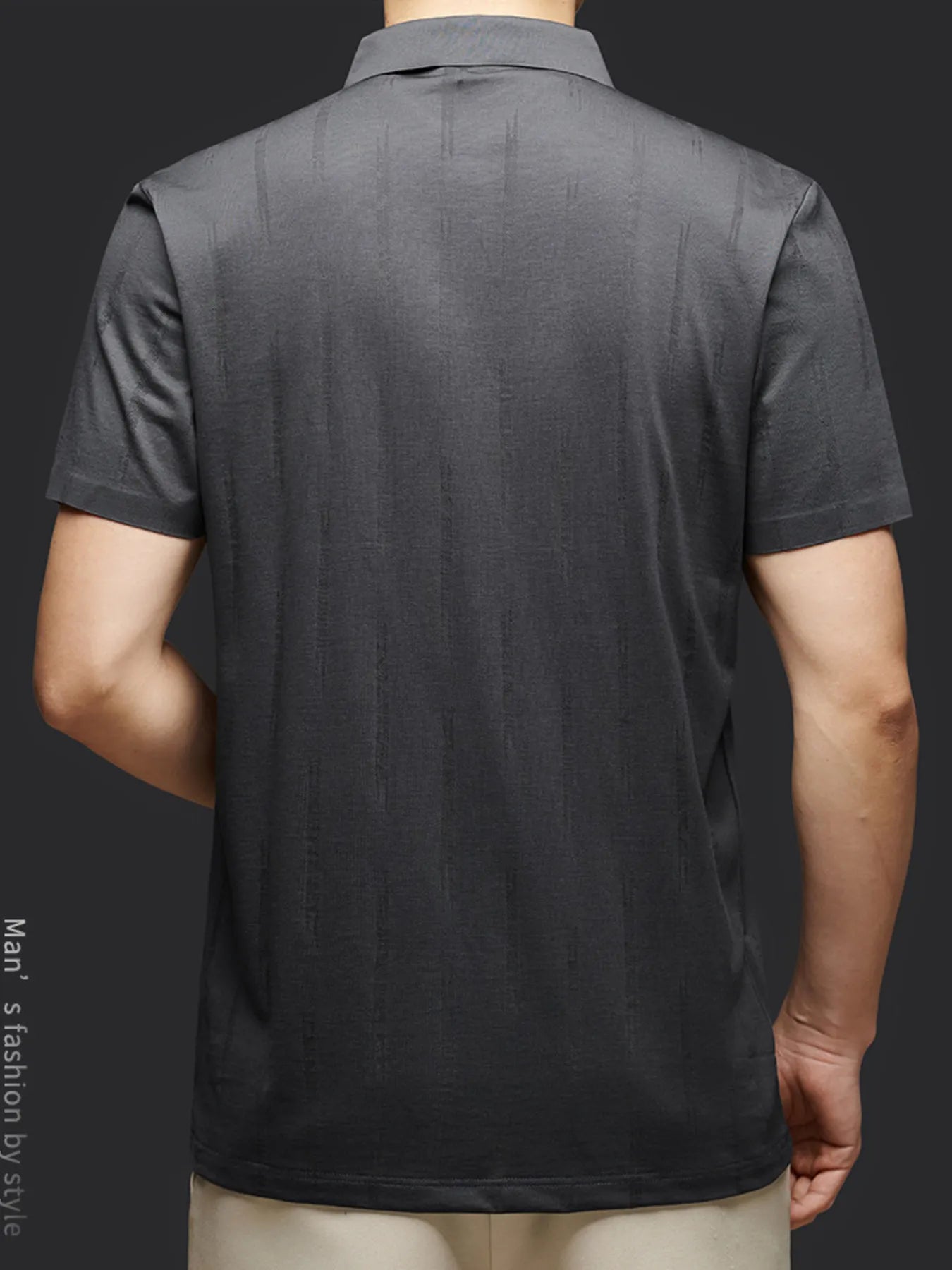 Back view of a person wearing a gray polo shirt on a dark background-blackorvani.com