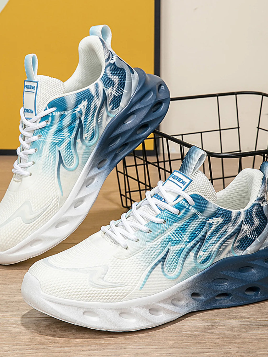 White and blue athletic shoes with a visible brand logo on a wooden floor.
