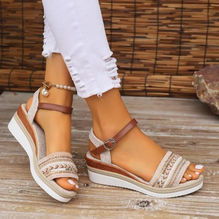 Brown wedge sandals with decorative straps worn on a wooden floor-blackorvani.com