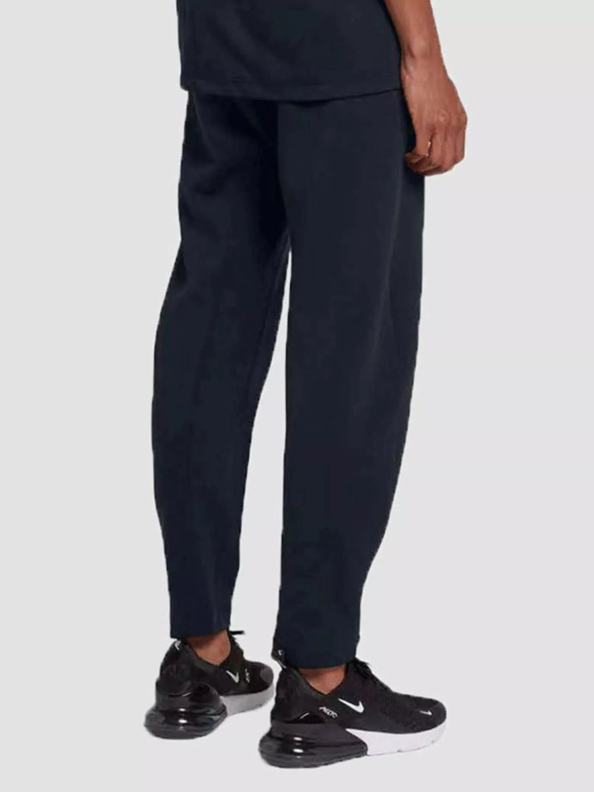 Person wearing navy blue pants and black sneakers on a white background-BlackOrvani