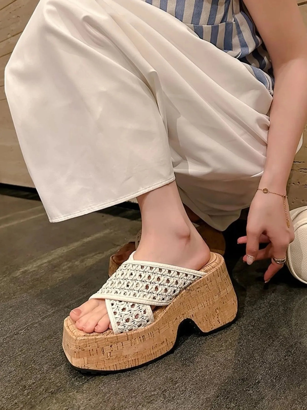 White sandal with cork platform worn by a person sitting on the floor-blackorvani.com