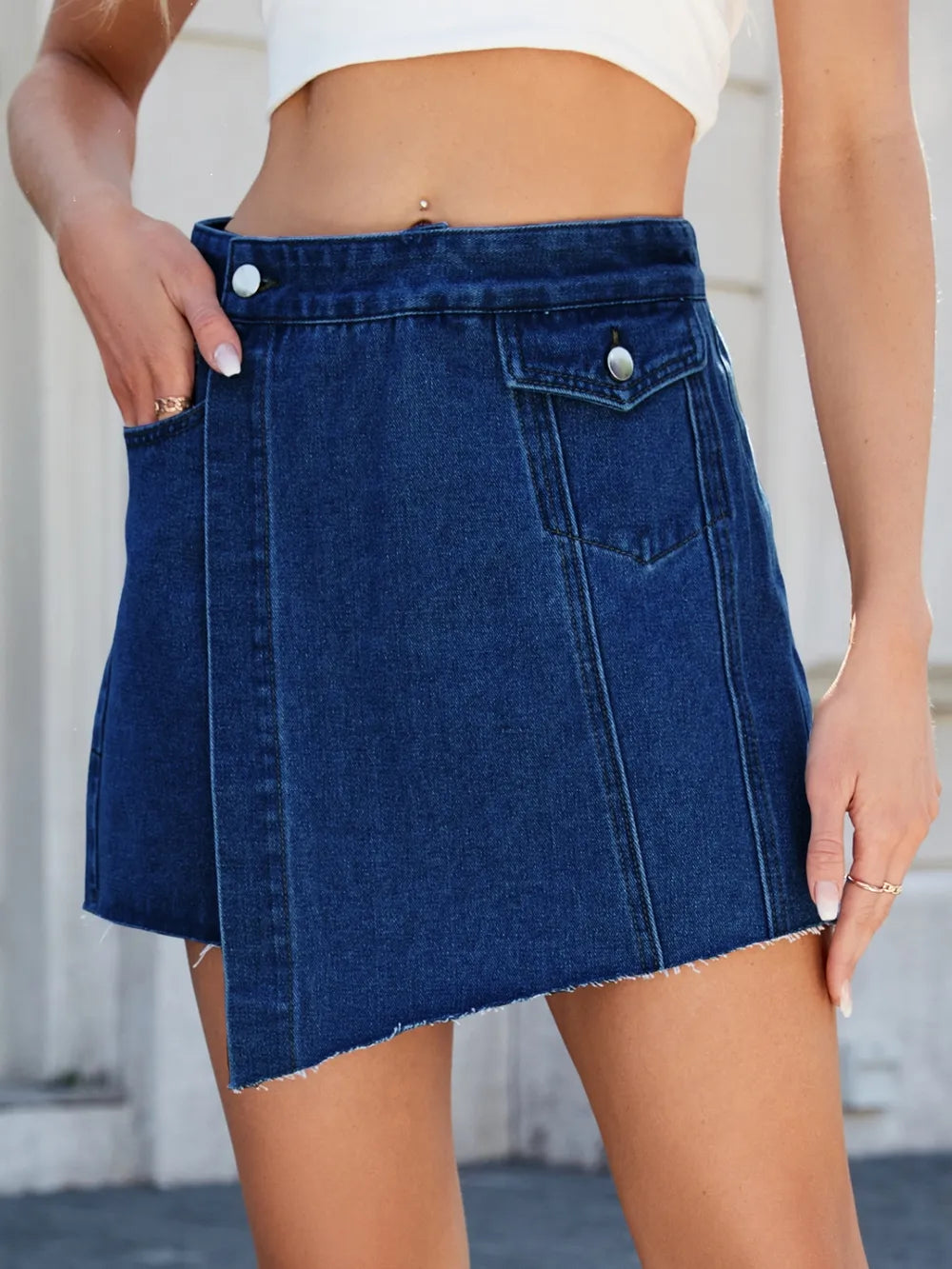 Blue denim skirt worn by a person with a blurred background-blackorvani.com