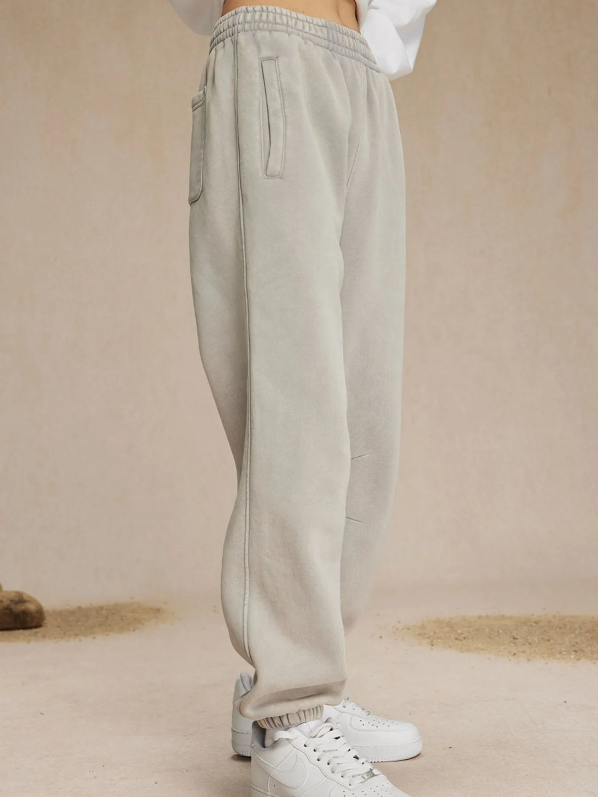 Beige sweatpants worn by a person on a beige background-blackorvani.com