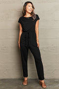 Woman wearing a black jumpsuit-BlackOrvani