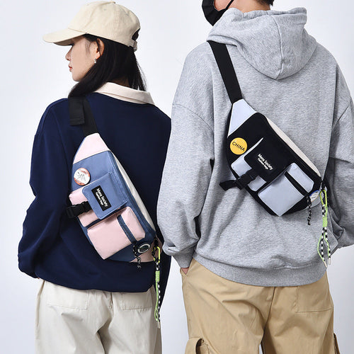 Two models wearing crossbody bags with visible branding on a plain background