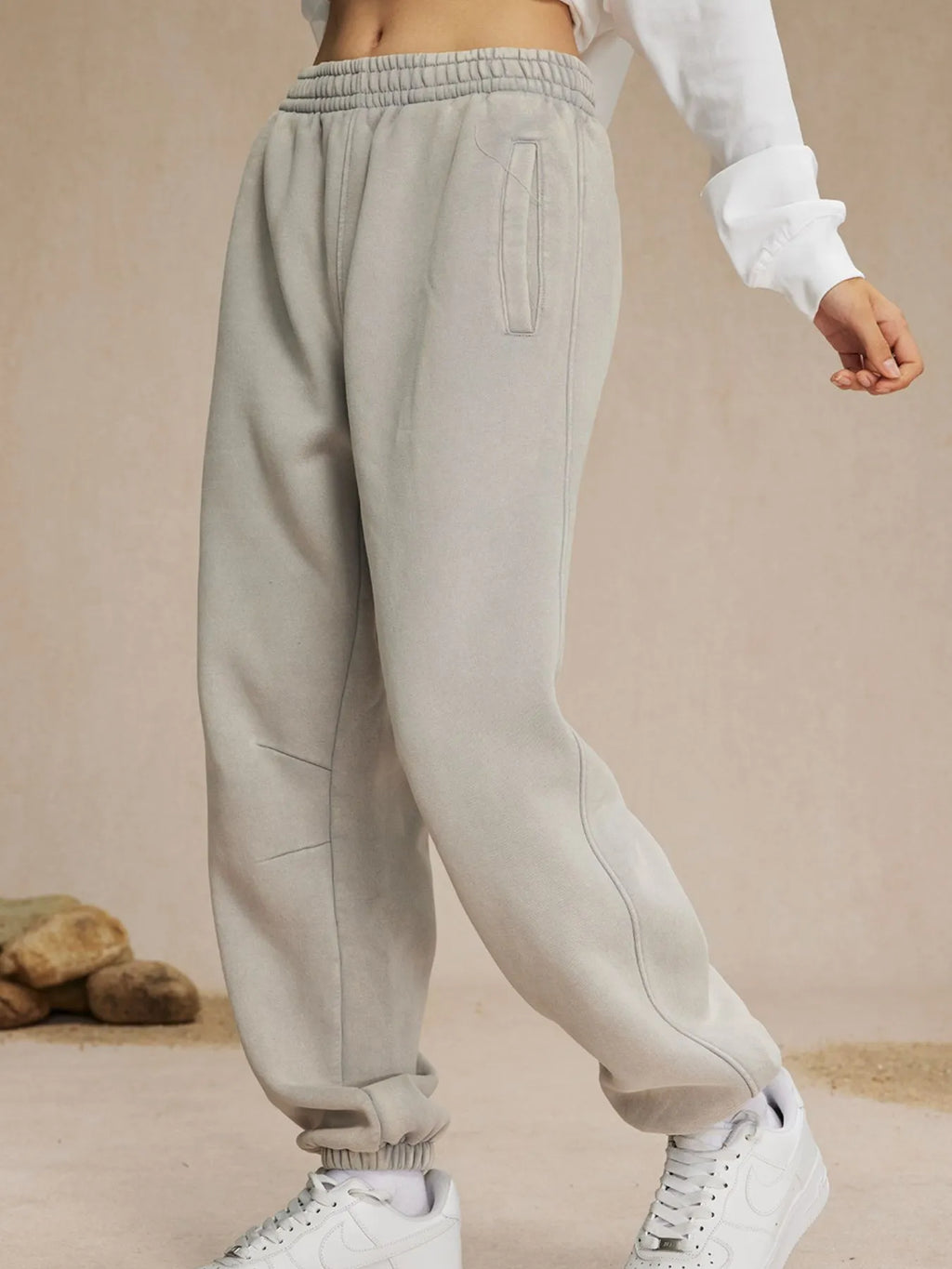 Beige sweatpants worn by a person on a beige background-blackorvani.com