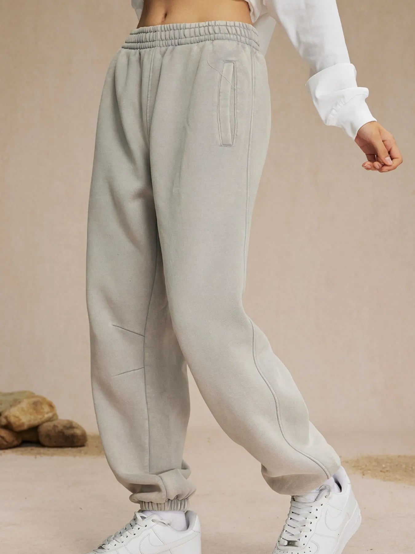Beige sweatpants worn by a person on a beige background-blackorvani.com