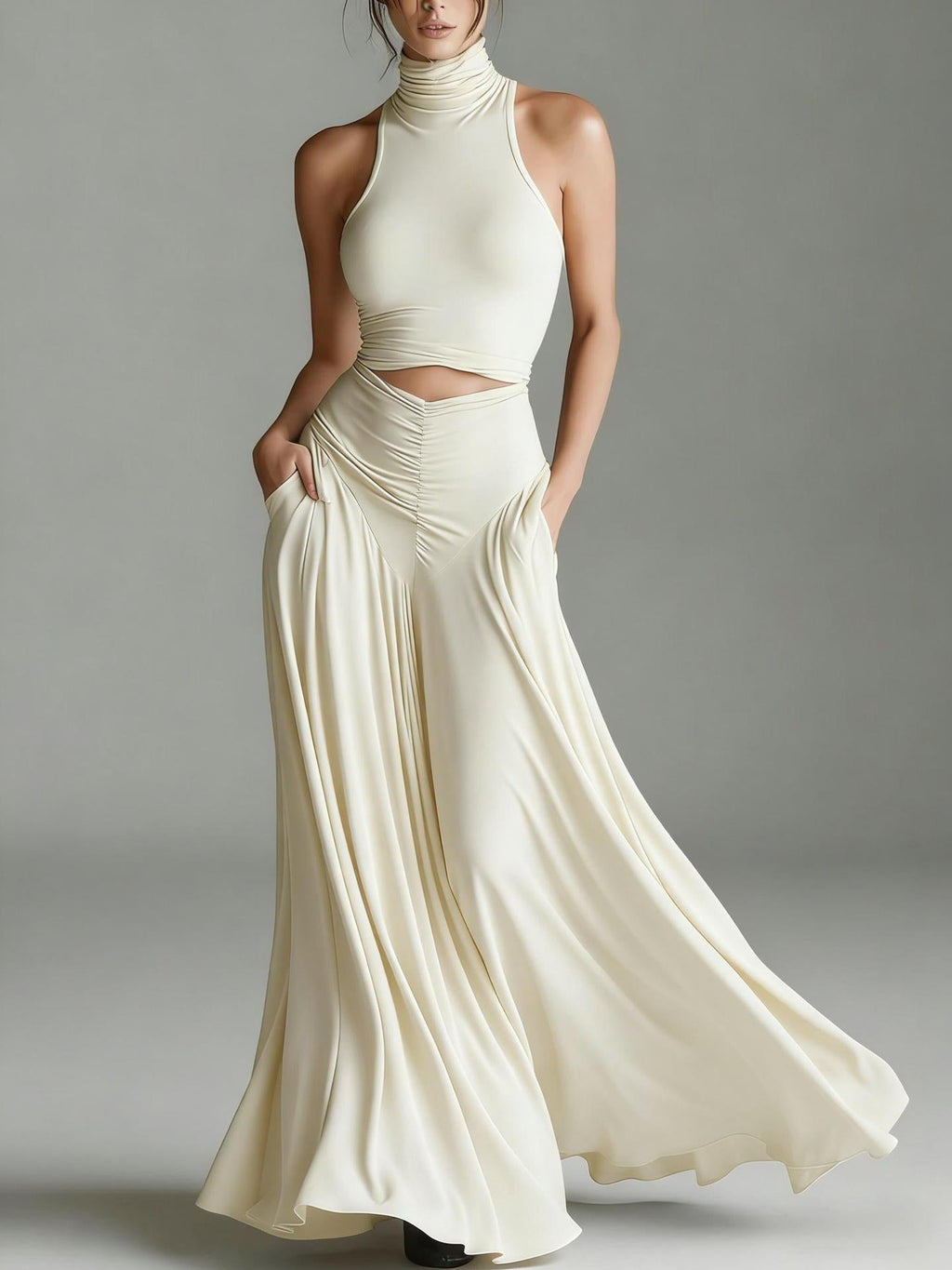Woman wearing a flowing white dress against a gray background
