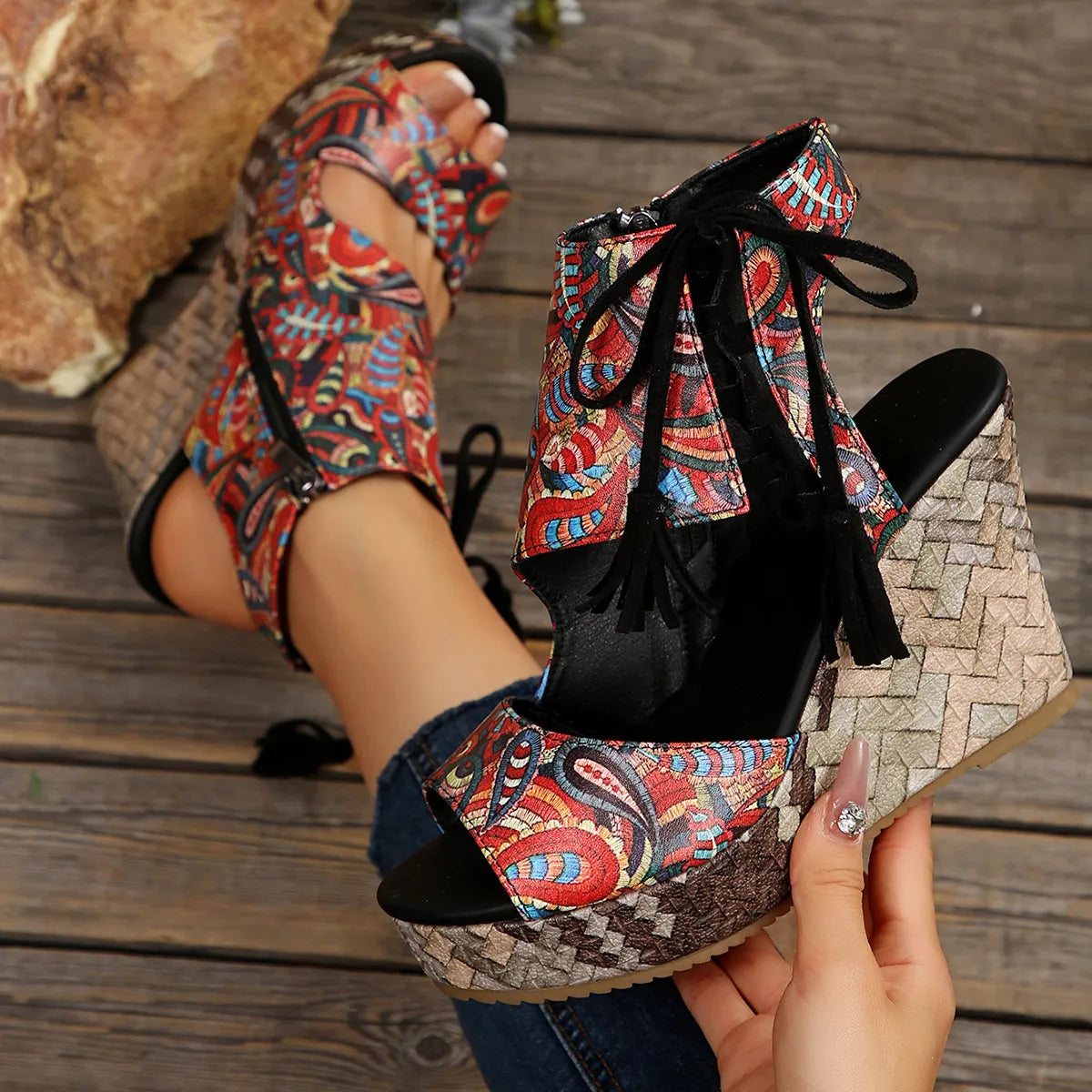 Colorful patterned high-heeled shoes on a wooden floor