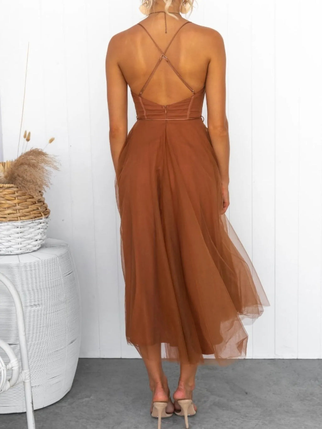 Brown dress with open back worn by a person, standing against a white wall-blackorvani.com