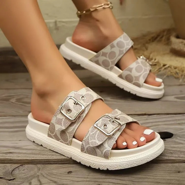 Patterned sandals with buckles on a wooden floor