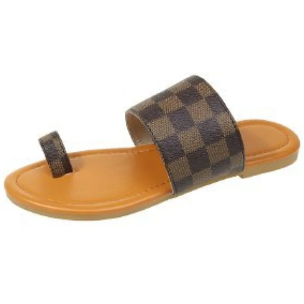 Brown checkered sandal with orange sole on a white background