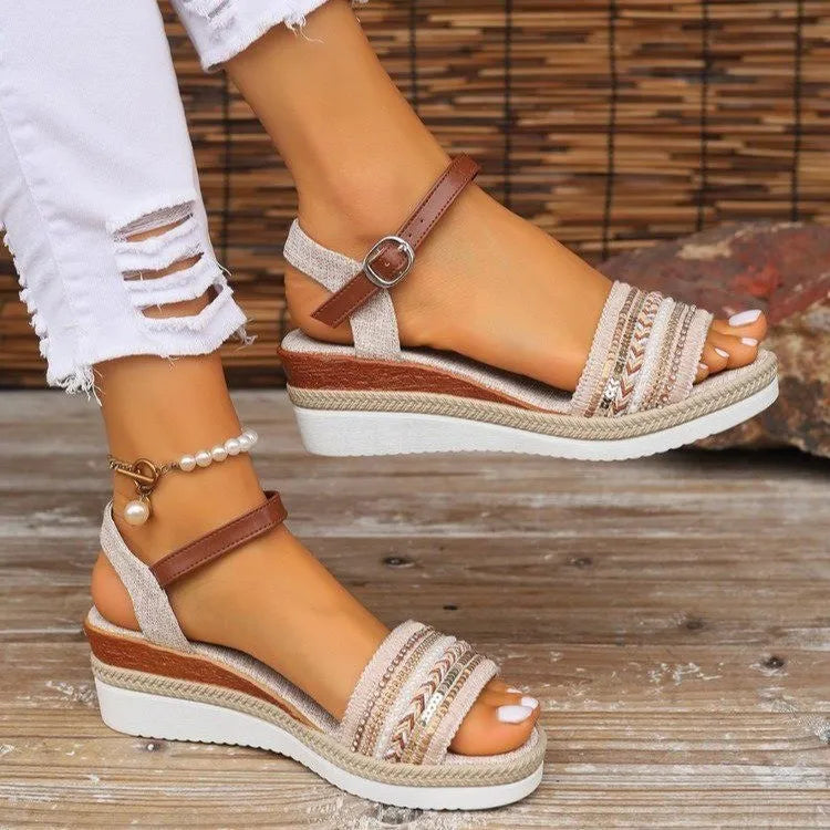 Beige wedge sandals with brown straps worn on a wooden floor-blackorvani.com