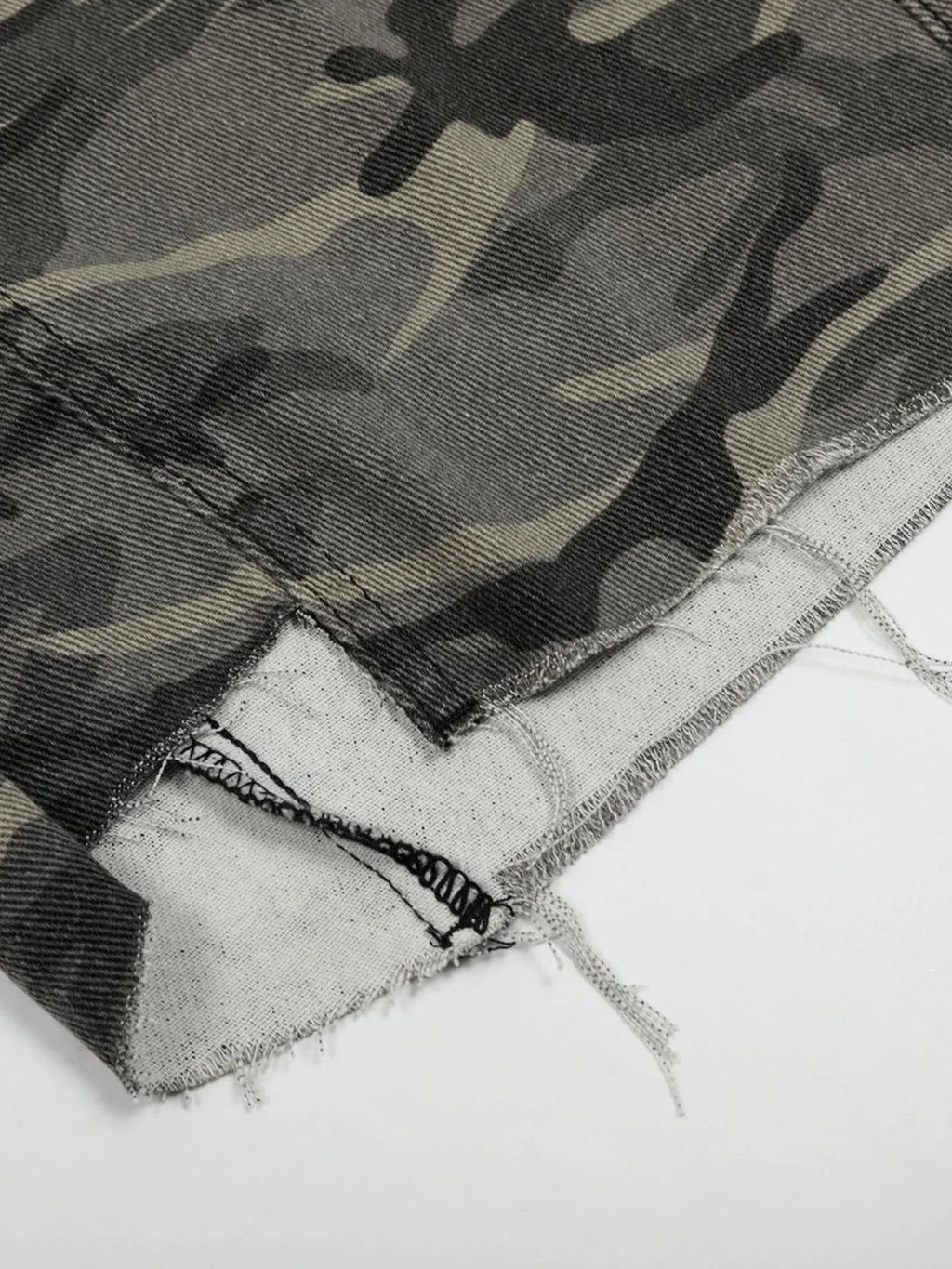 Close-up of a camouflage-patterned fabric with a white background-Black Orvani