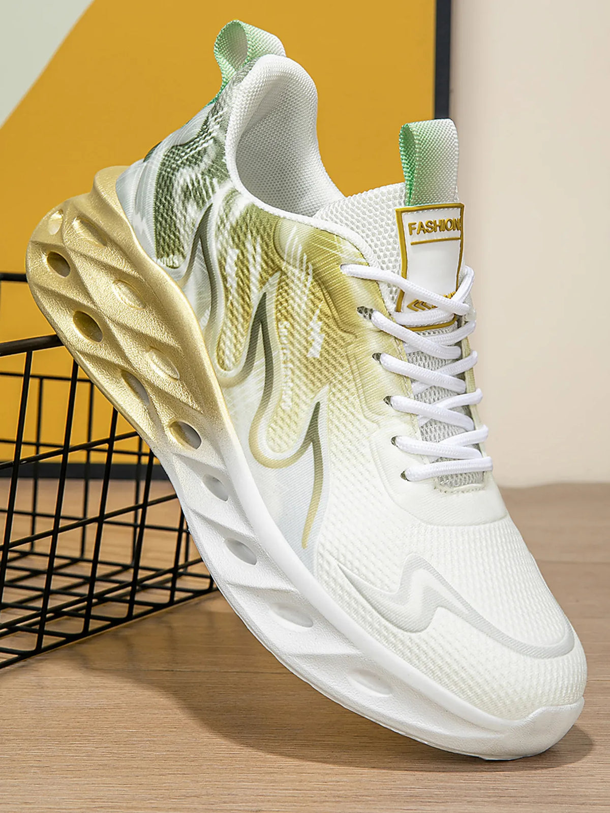 White and green sneaker with a thick sole on a wooden surface.