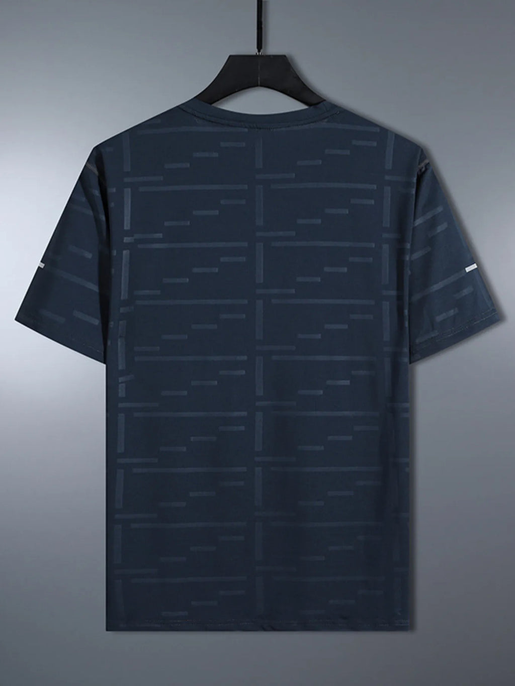 Dark gray t-shirt with geometric pattern on a hanger against a gray background-blackorvani.com