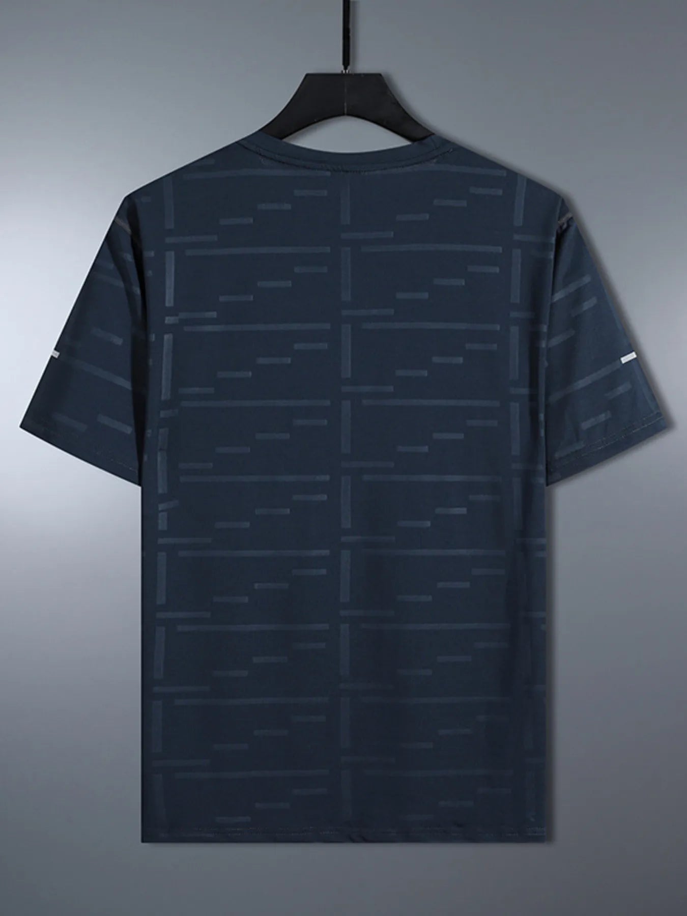 Dark gray t-shirt with geometric pattern on a hanger against a gray background-blackorvani.com