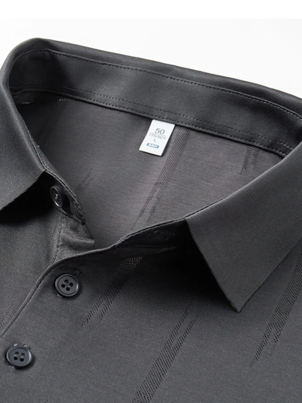 Close-up of a gray shirt collar with buttons and a brand label on a white background-blackorvani.com