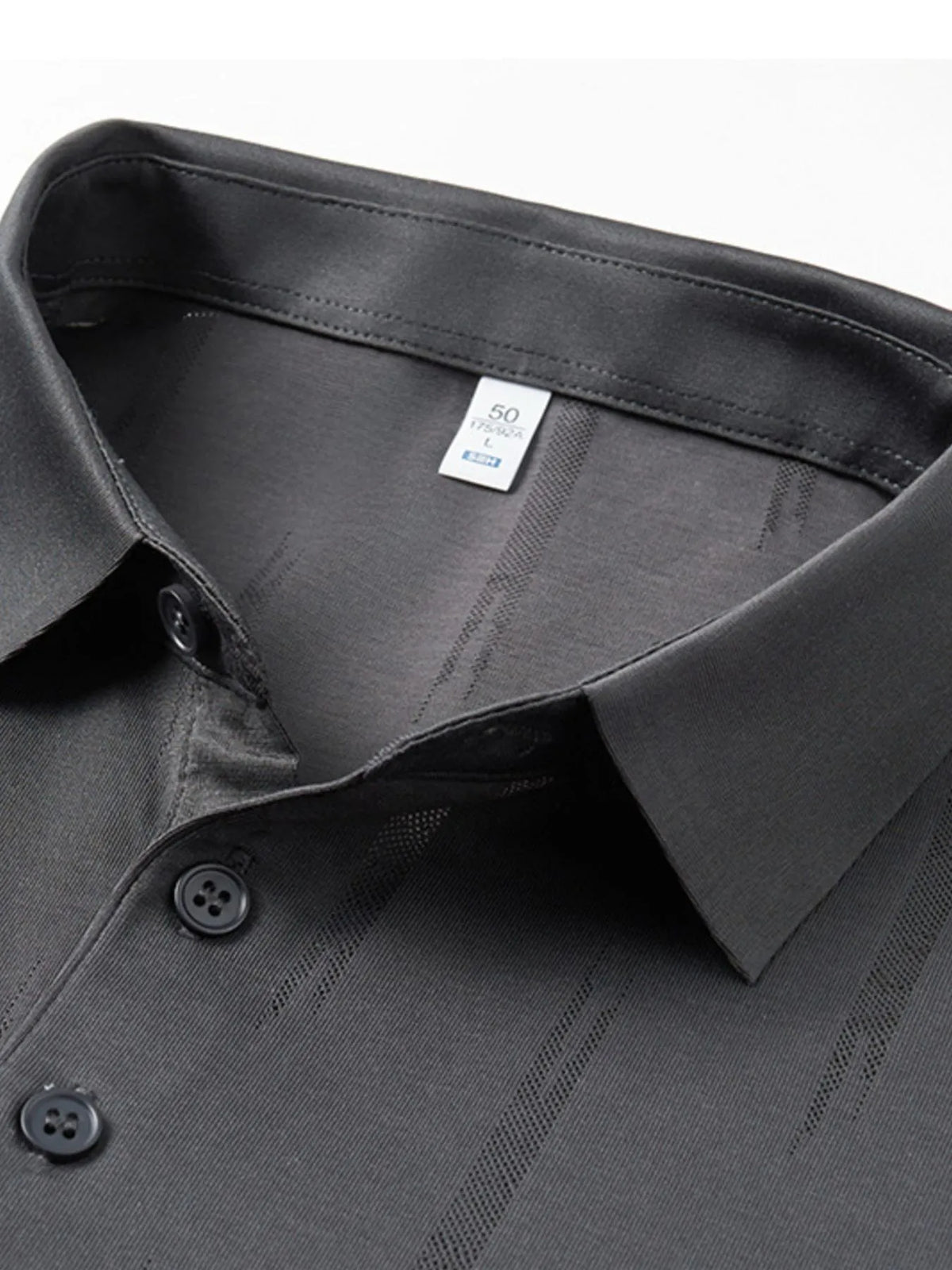 Close-up of a gray shirt collar with buttons and a brand label on a white background-blackorvani.com