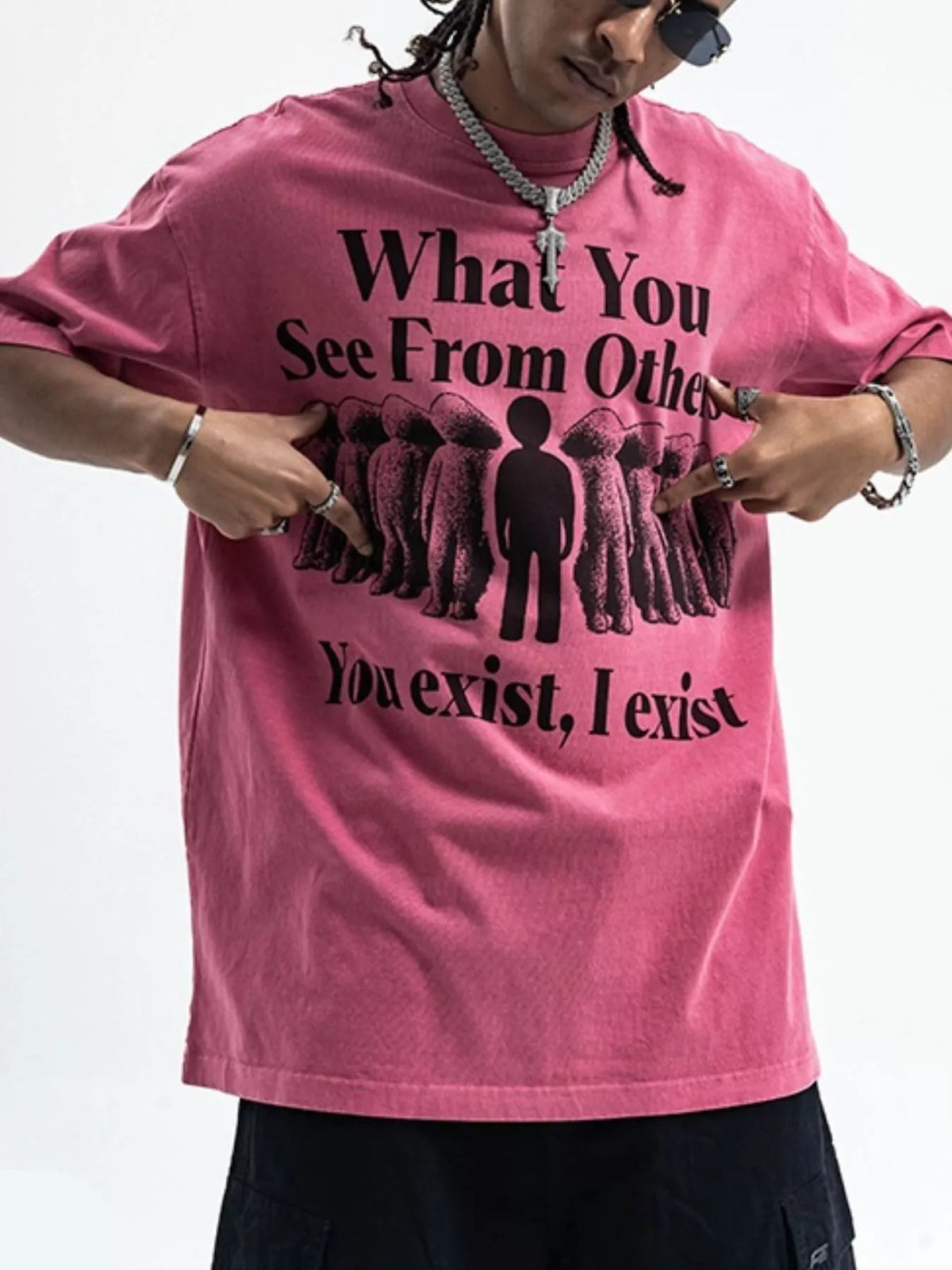Person wearing a pink t-shirt with a black graphic and text-blackorvani.com
