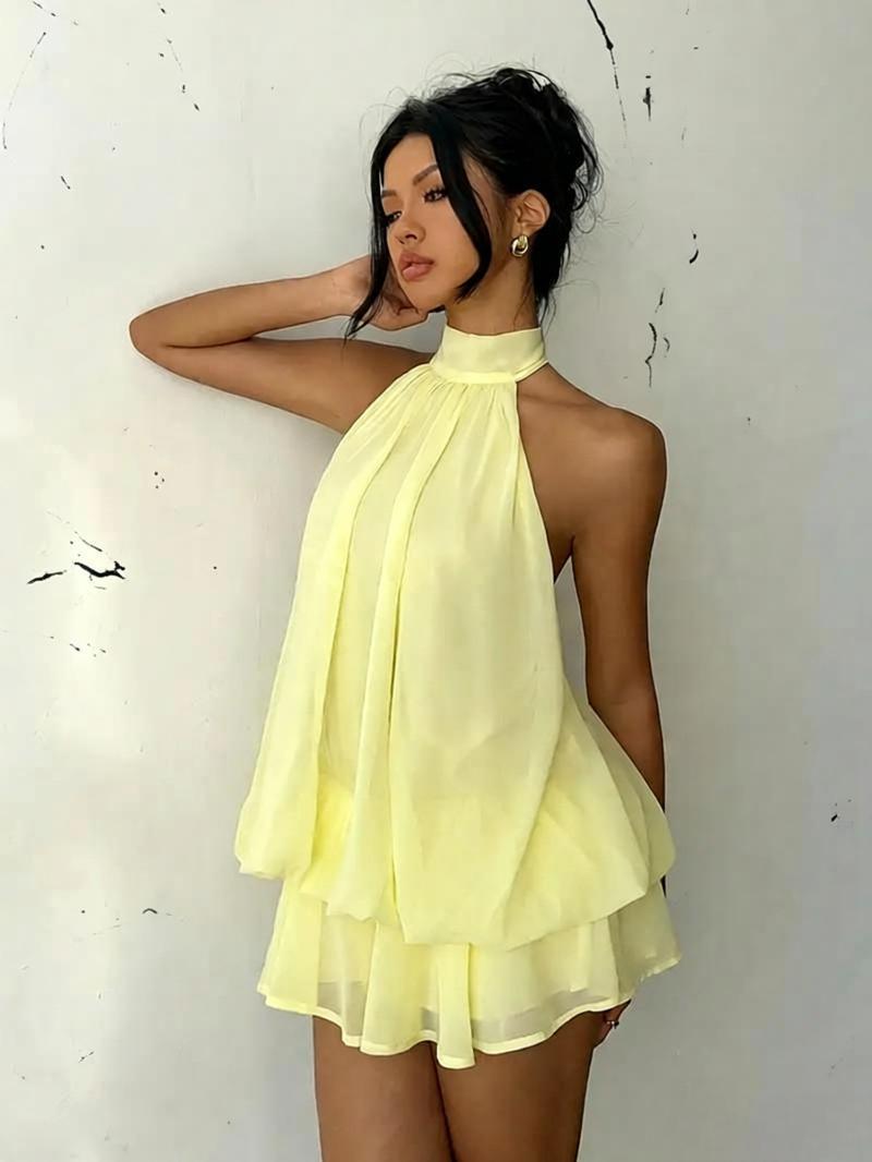 Woman wearing a yellow dress against a white background