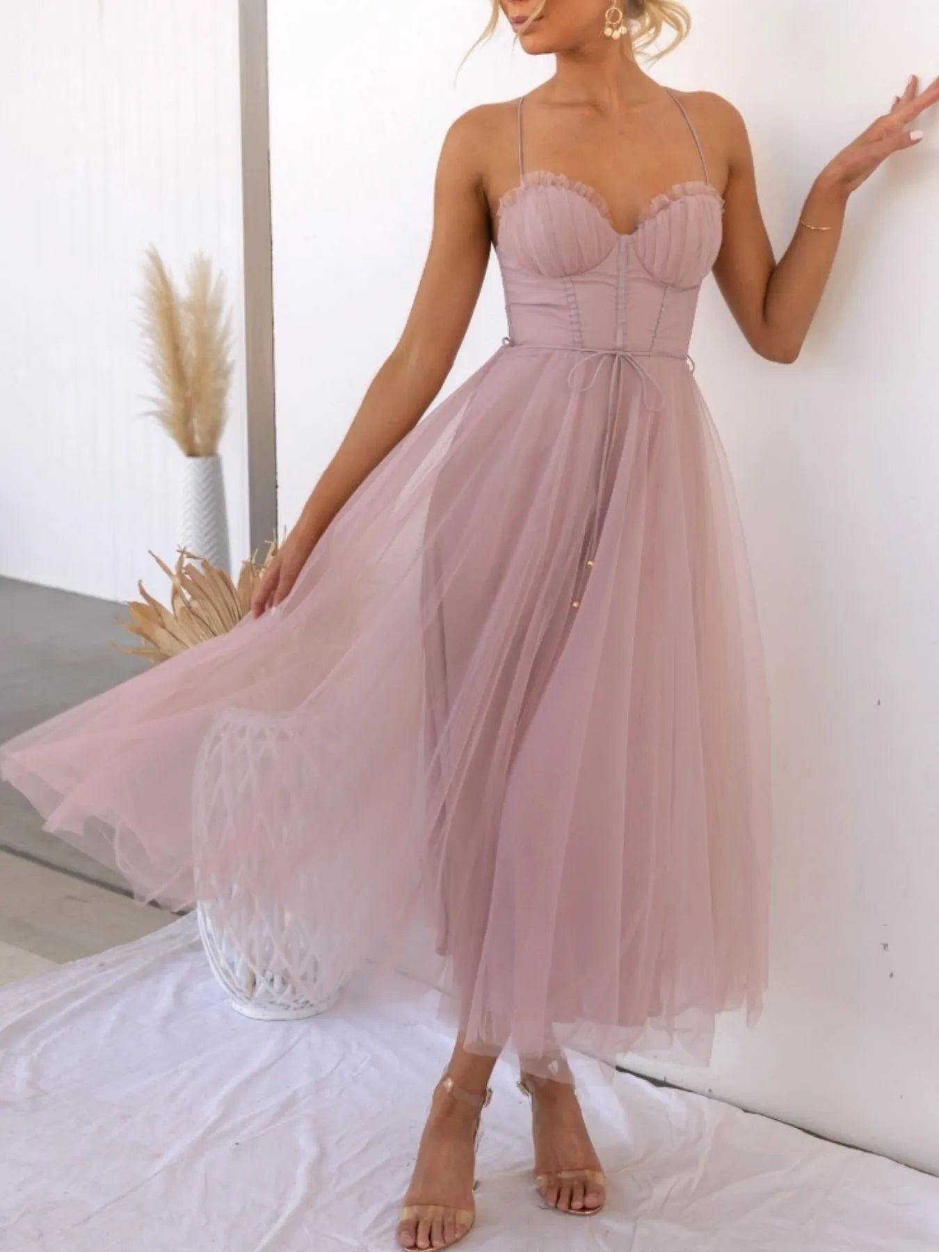 Woman wearing a pink dress with a white background-blackorvani.com