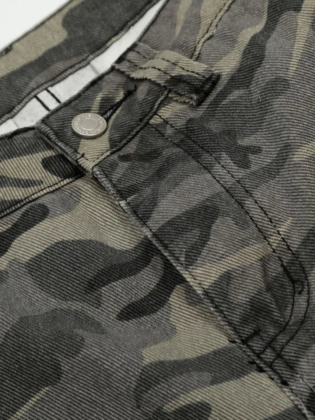 Close-up of camouflage pants with a button and stitching detail-Black Orvani