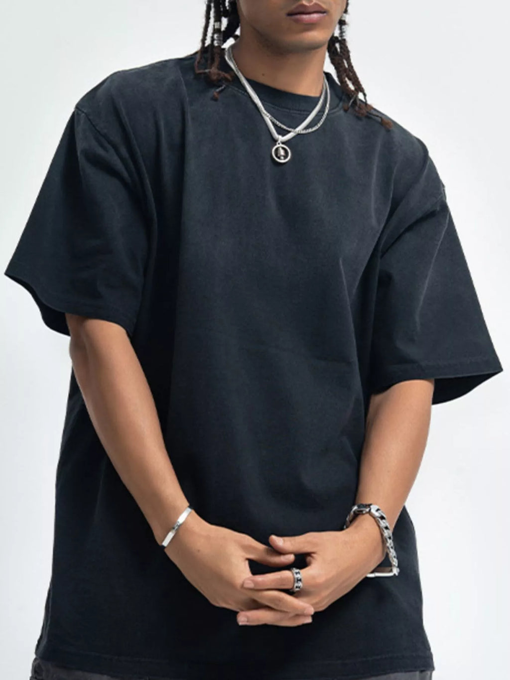 Person wearing a black t-shirt on a white background-blackorvani.com