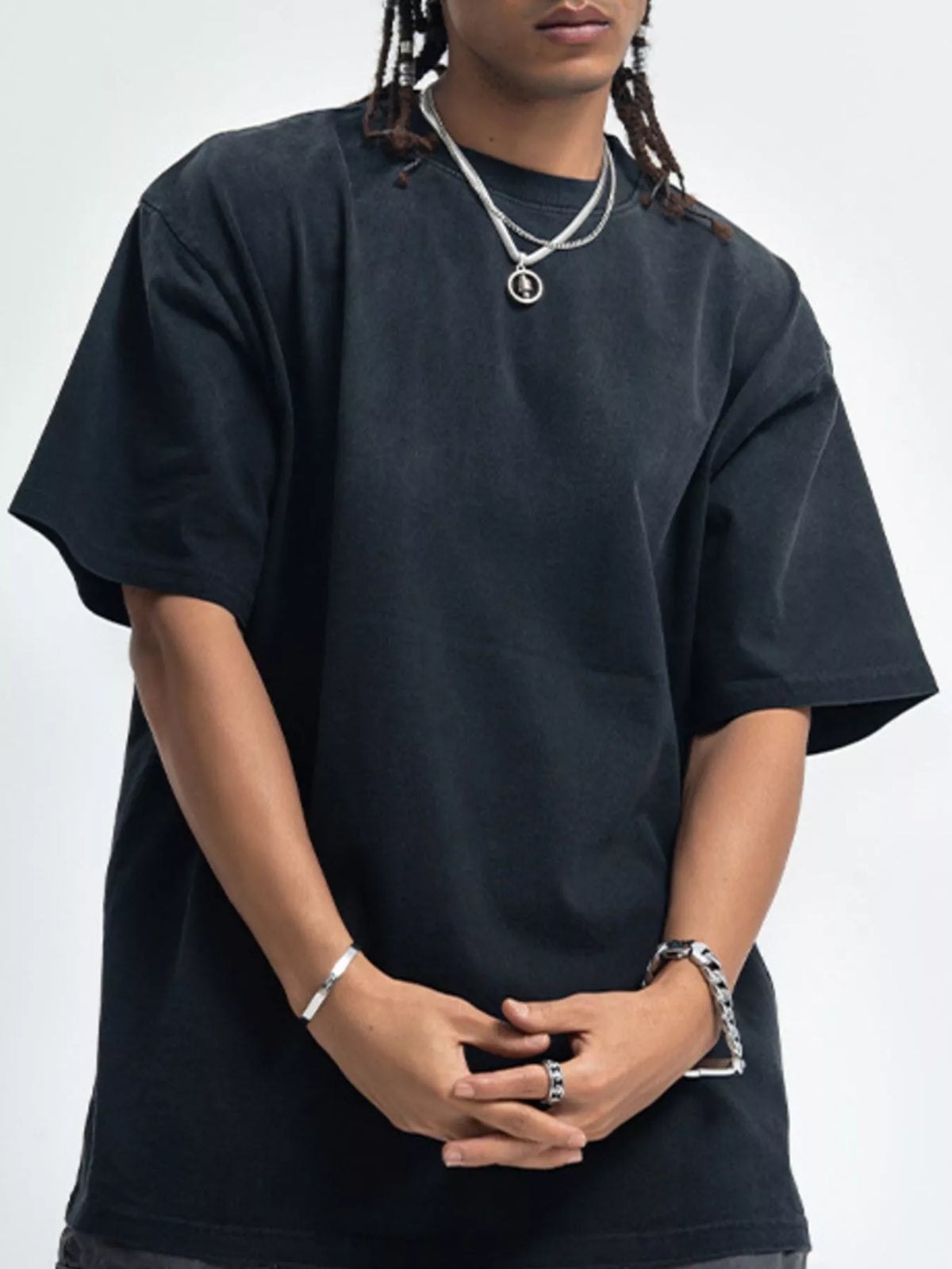 Person wearing a black t-shirt on a white background-blackorvani.com