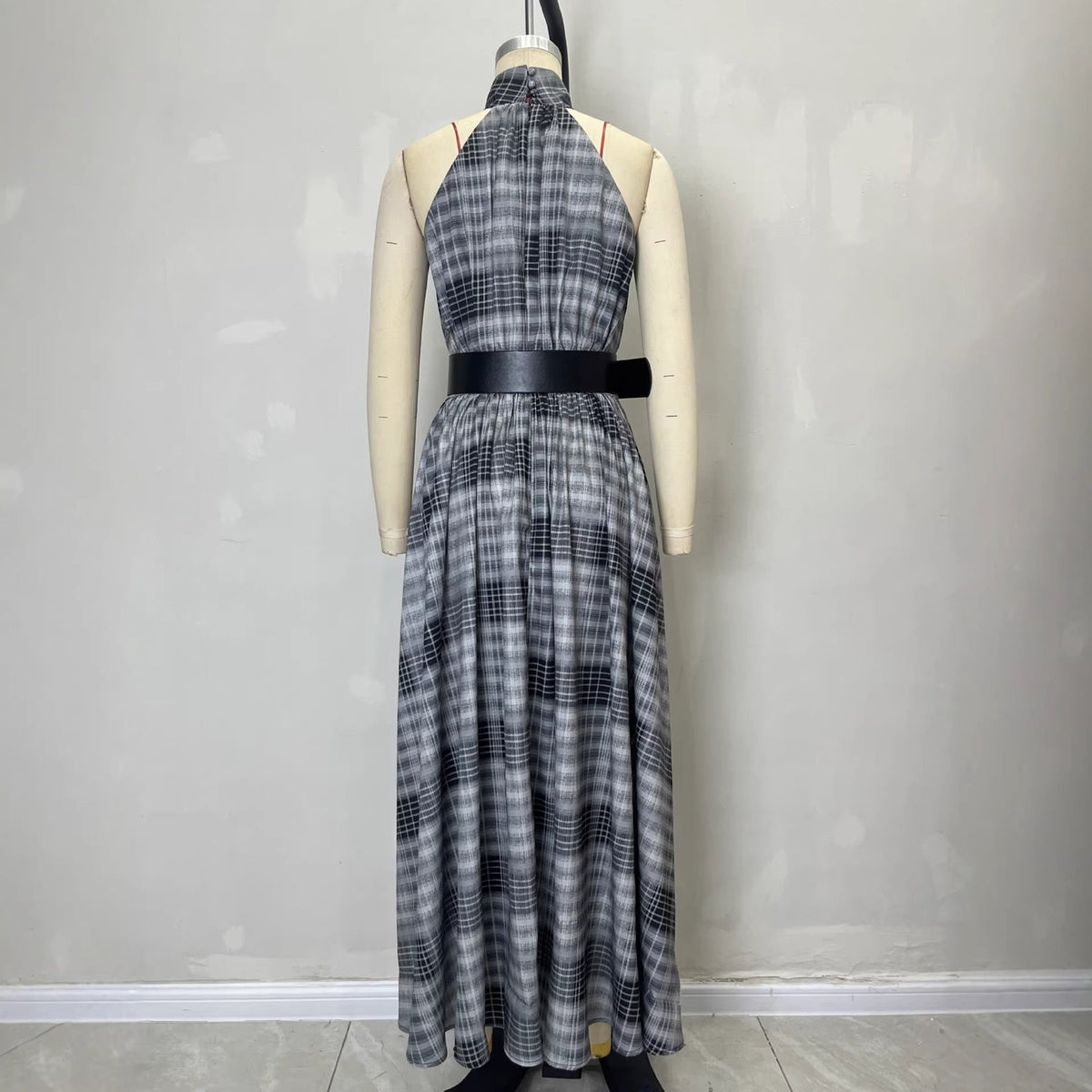 Plaid dress on a mannequin against a plain background
