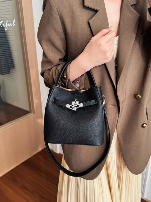 women holding a black handbag -BLACKOrVaNi