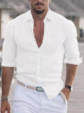Man wearing a white button-up shirt with rolled-up sleeves and light blue pants.