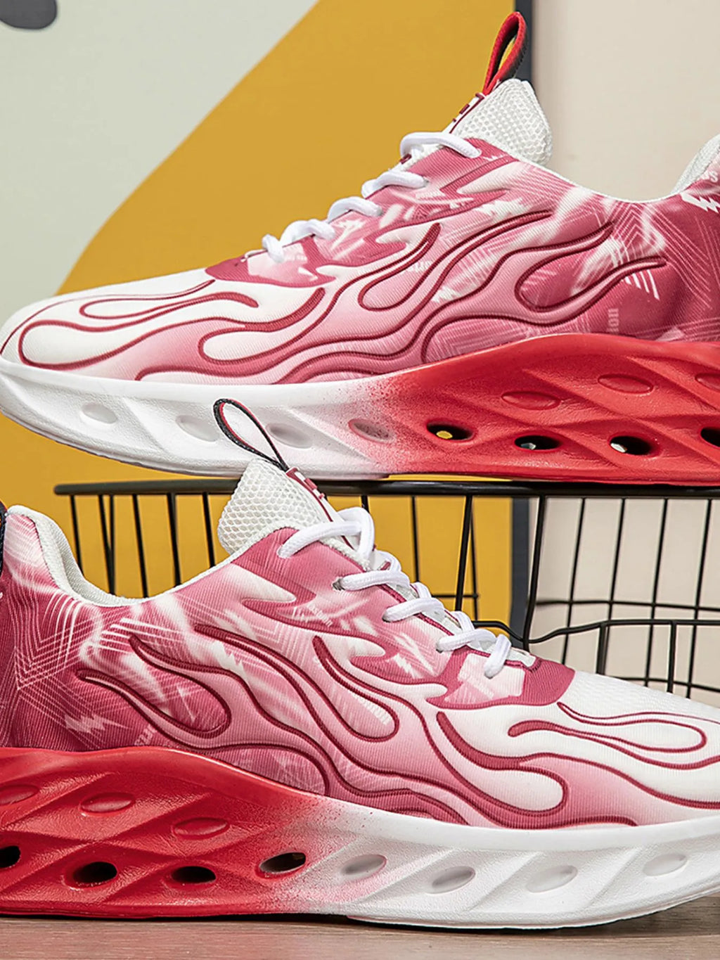 Pink and red sneakers with white soles on a yellow background