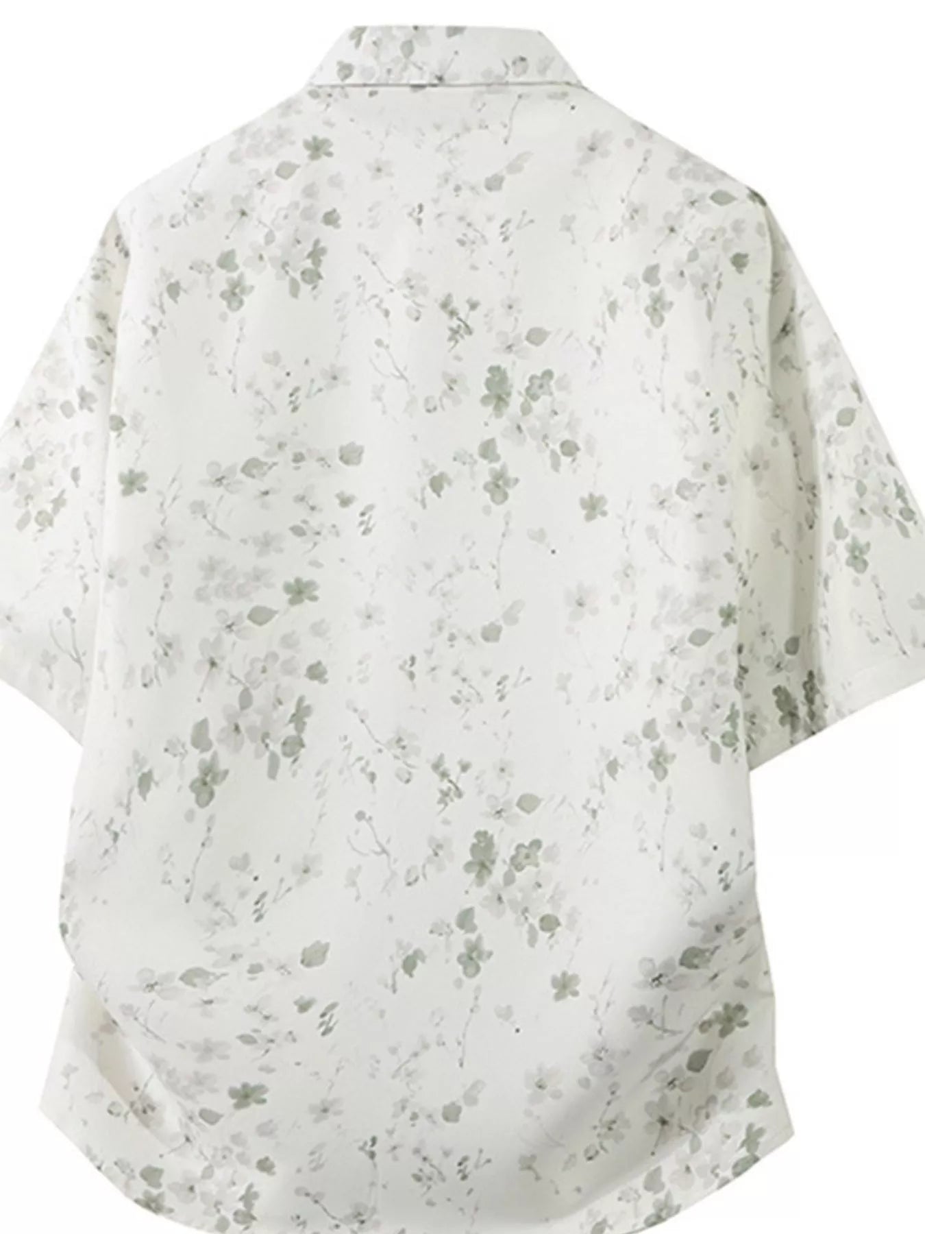 White shirt with subtle gray floral pattern on a white background