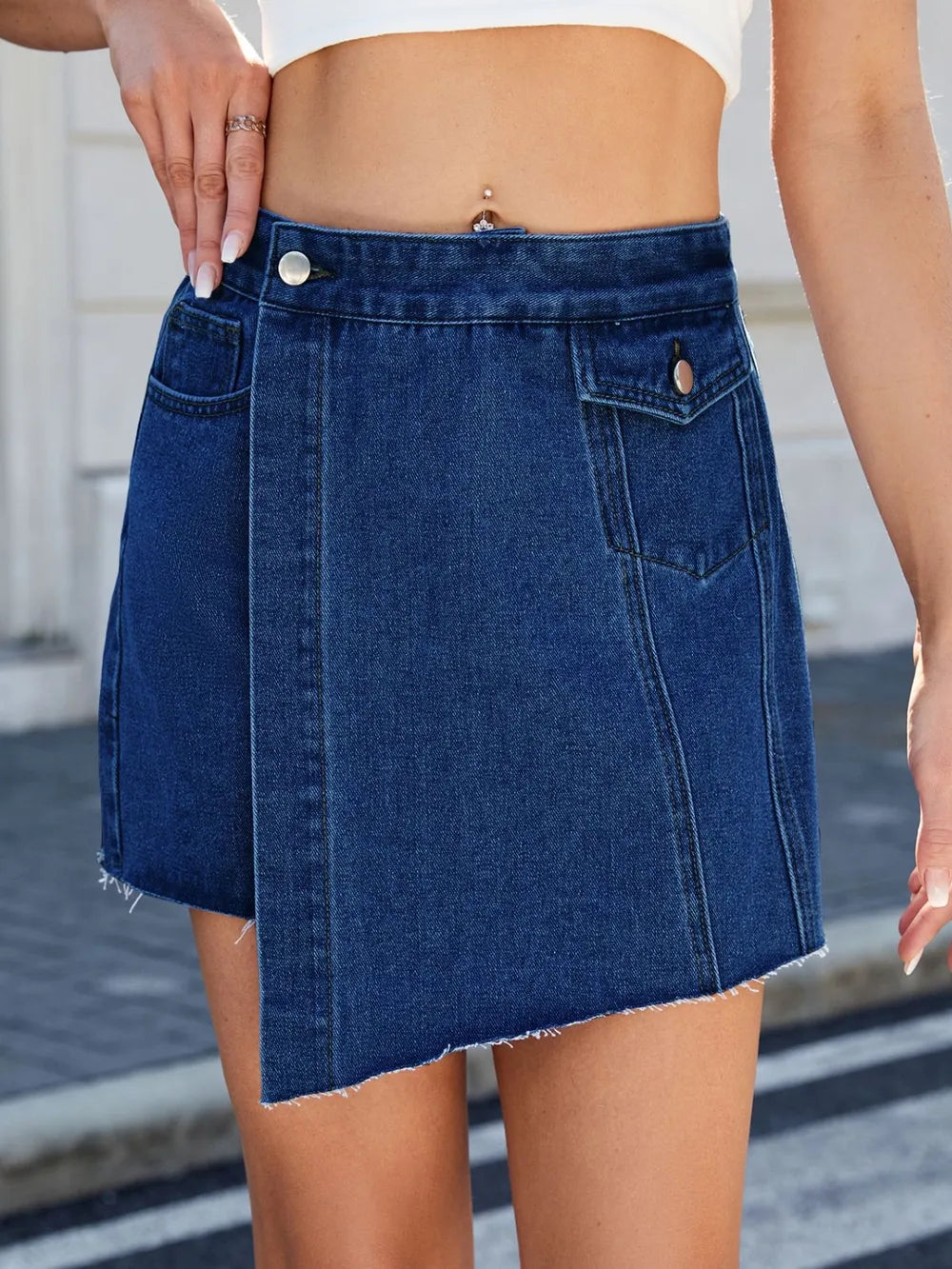 Blue denim skirt worn by a person with a blurred background-bblackorvani.com