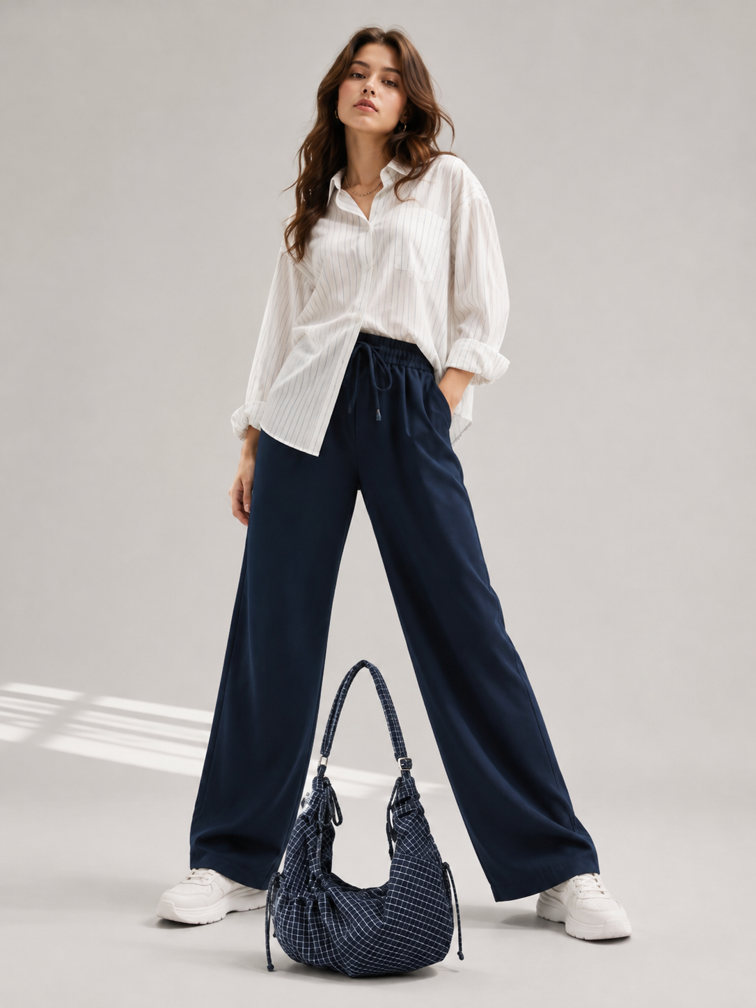 a navy patterned shoulder bag on the floor -BlackOrvani