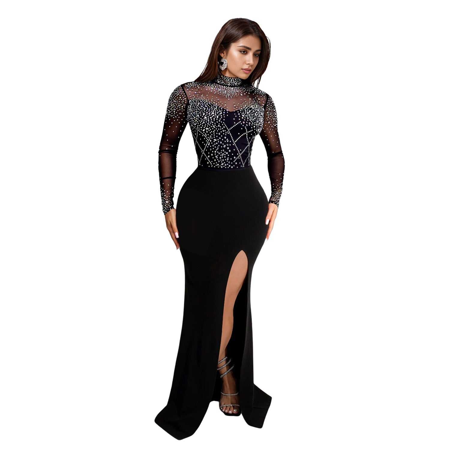 Woman wearing a black evening gown with a high slit on a white background