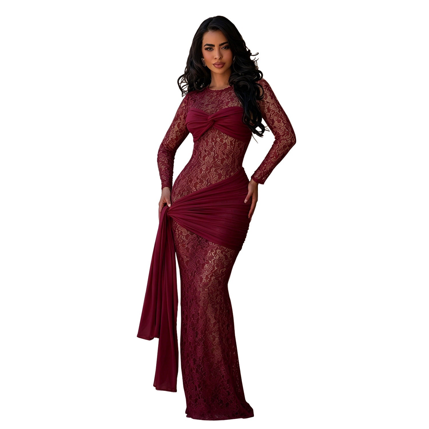 A woman modeling a long-sleeve burgundy lace evening gown with a draped waist and a matching flowing fabric panel, set against a plain white background.