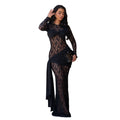 A woman modeling a long-sleeve black lace maxi dress with draped fabric details, holding a small black clutch against a plain white background.