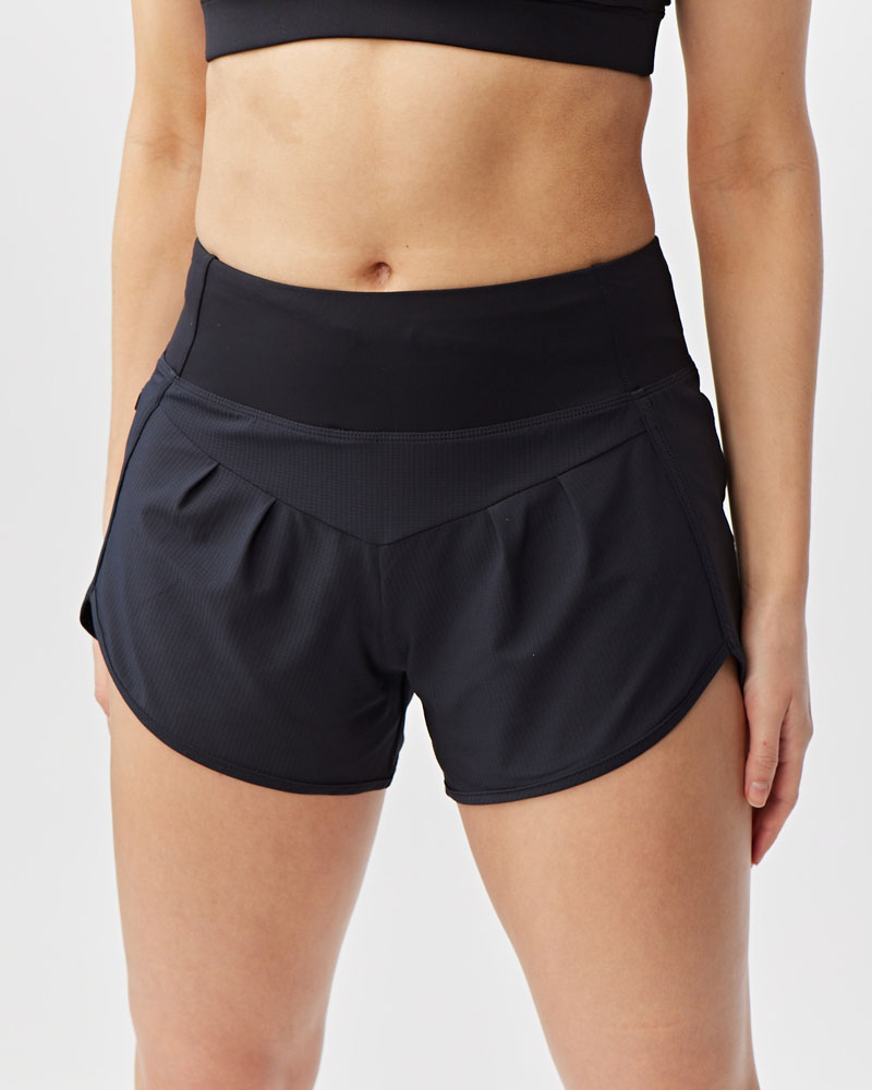 Black athletic shorts worn by a person on a light gray background