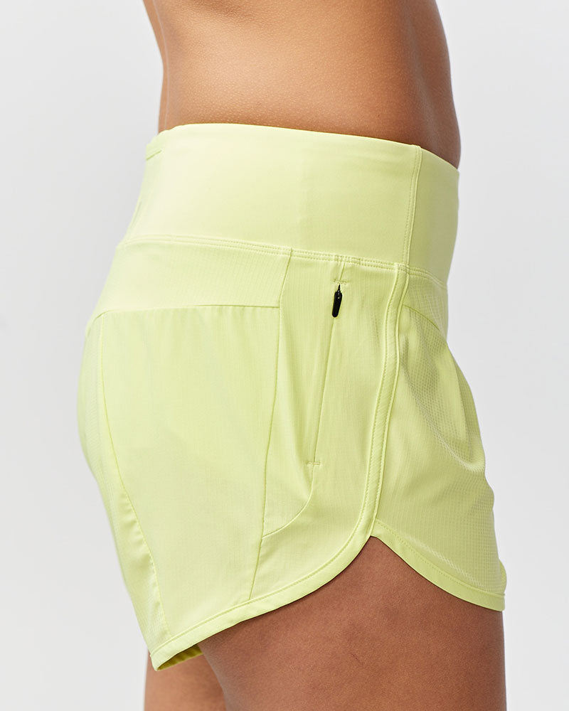 Light green athletic shorts on a plain background