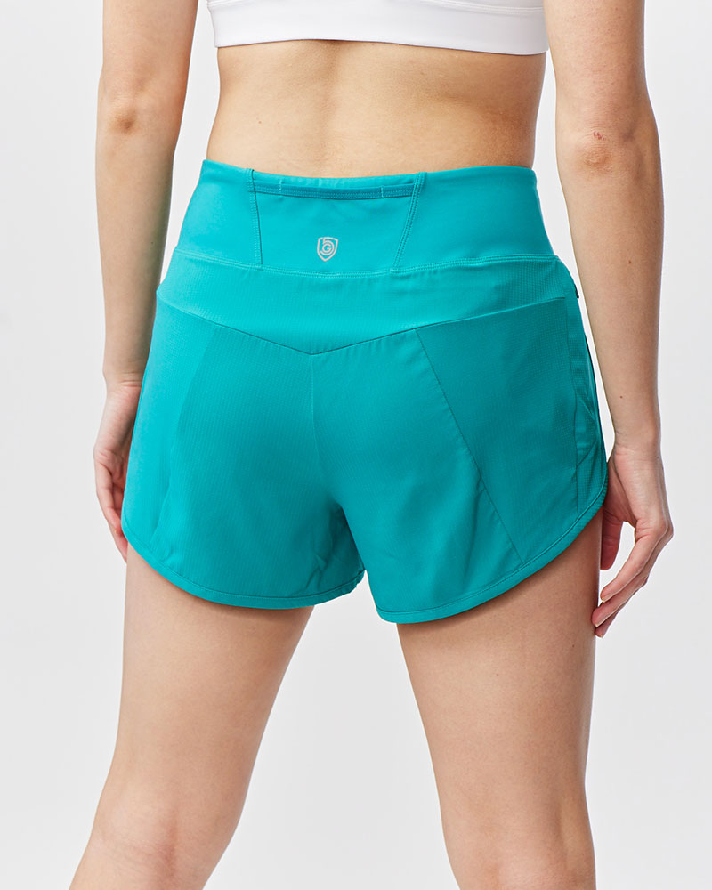 Teal athletic shorts worn by a person on a white background