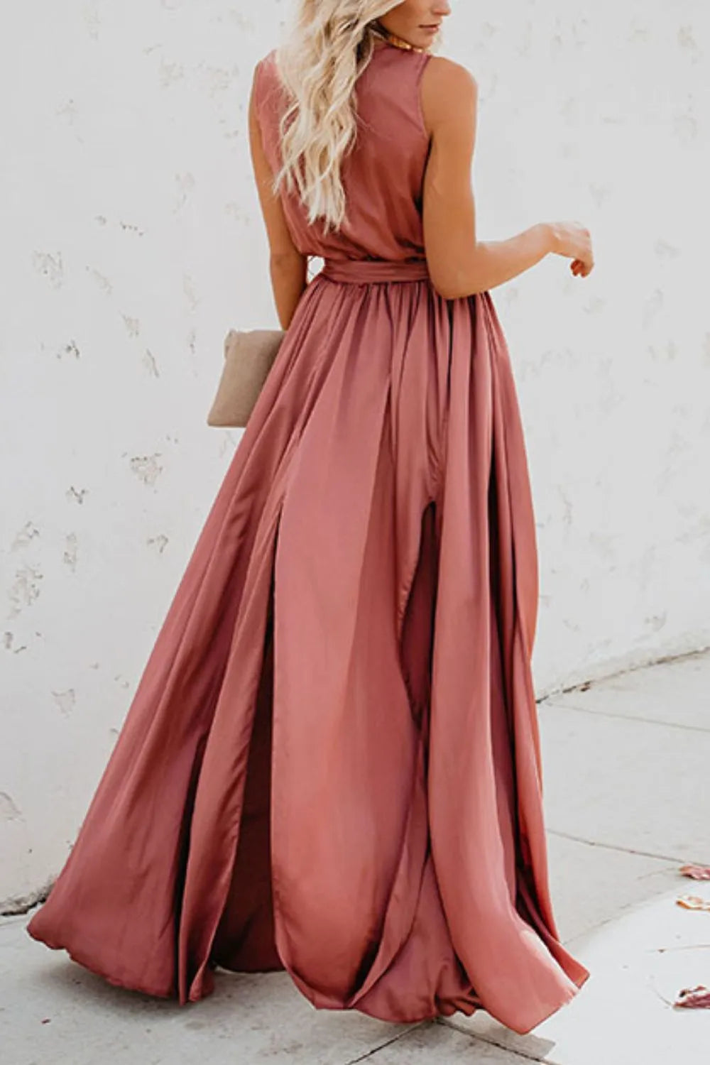 Woman wearing a long rust-colored dress against a light background-blackorvani.com