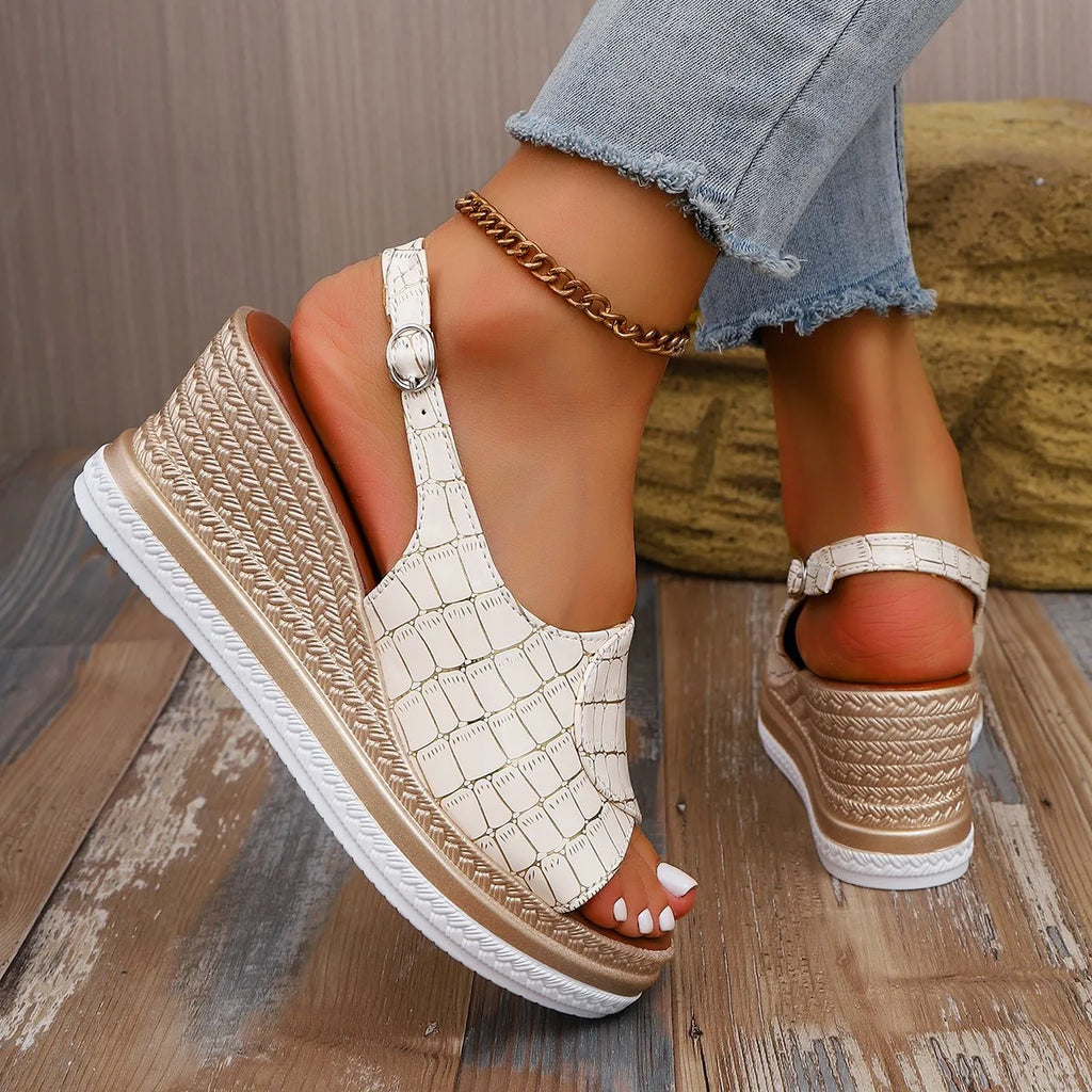 Beige wedge sandals with chain detail worn by a person sitting on a wooden floor-blackorvani.com