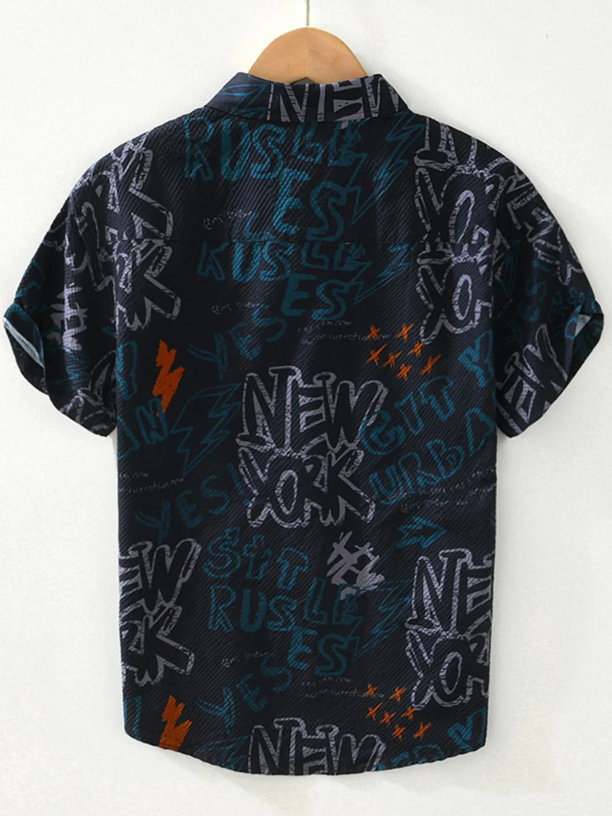 Black shirt with colorful text and graphics on a hanger against a white background-blackorvani.com