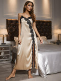 Woman in a beige satin nightgown with black lace trim standing in a bedroom.-blackorvani