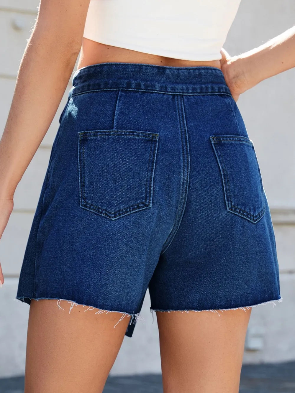 Blue denim skirt worn by a person with a blurred background-bblackorvani.com
