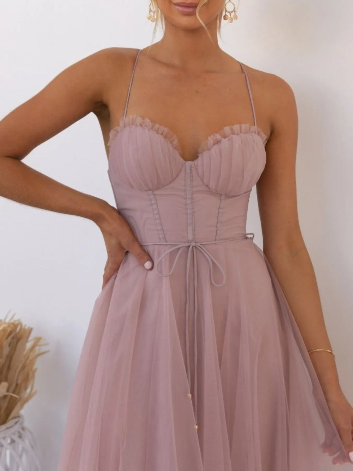 Woman wearing a pink dress with thin straps against a white background-blackorvani.com