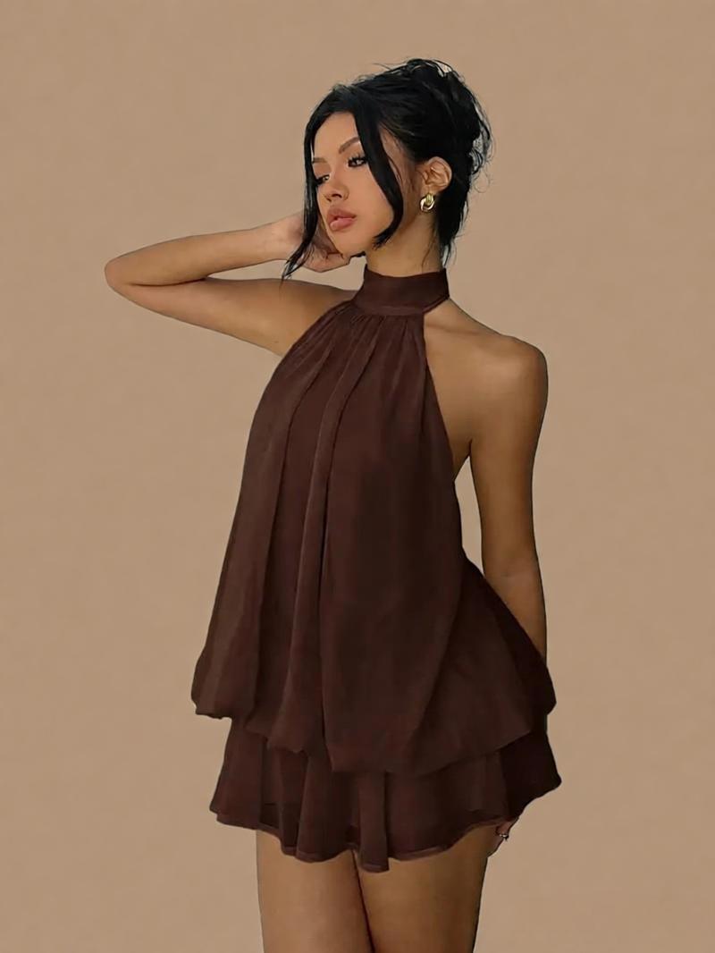 Woman wearing a brown halter neck dress against a beige background