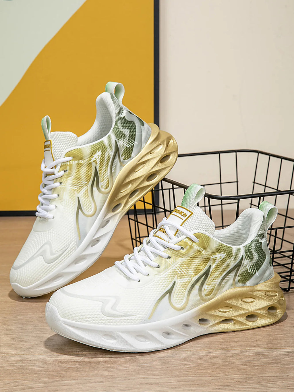 White sneakers with gold and green design on a wooden floor.